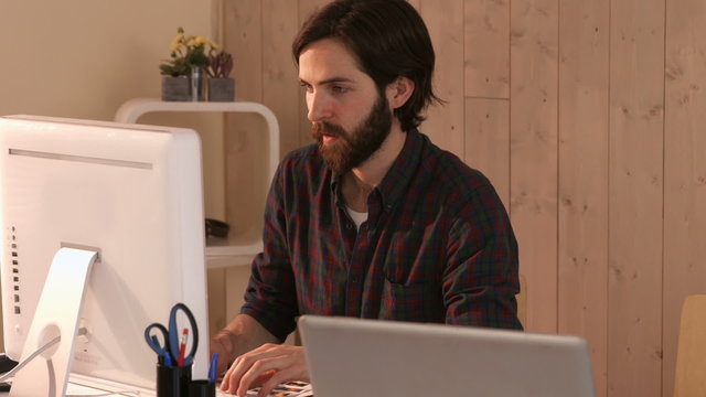 Casual hipster designer working on a computer
