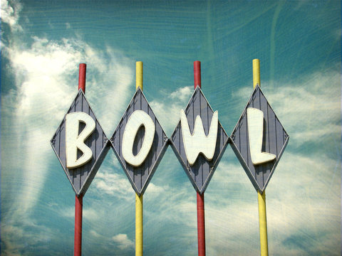 aged and worn vintage photo of bowling alley sign