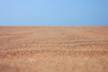 Dry beach sand and clear blue sky
