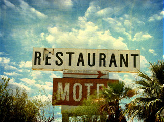 aged and worn vintage restaurant and motel sign