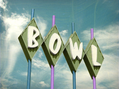 aged and worn vintage photo of bowling alley sign