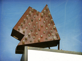 aged and worn vintage photo of arrow sign