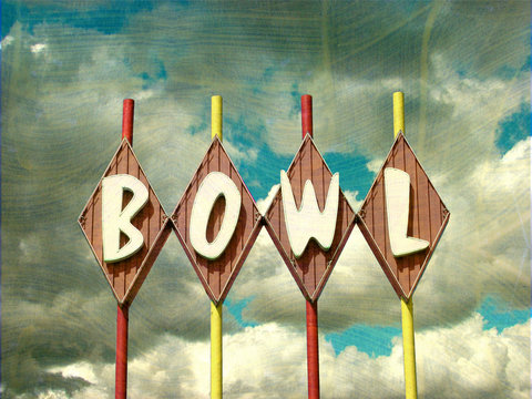 aged and worn vintage bowling alley sign