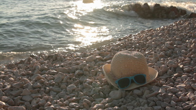 hat and sunglasses on beach