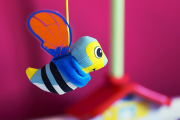 Little bee hanging above baby bed