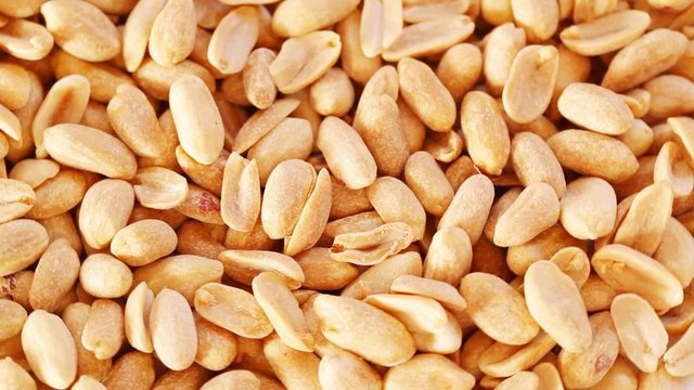Roasted salty peanuts seed at rotating stand; close up; no people; HD 1080 