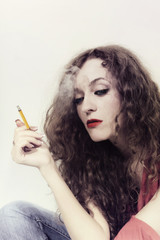 curly long-haired brunette woman with yellow cigarette