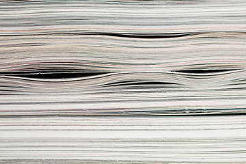 Side view of stack of papers, books, and magazines for recycling