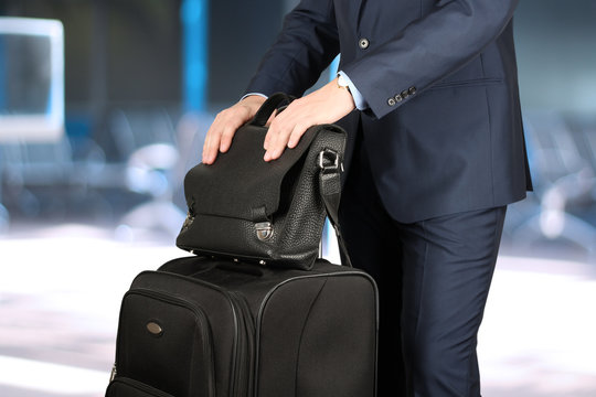 young businessman  in  a modern  stylish suit with  luggage in