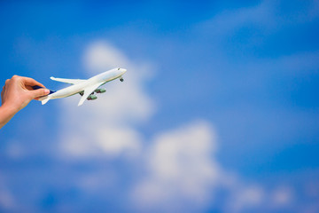 Little white airplane model in female hand background of