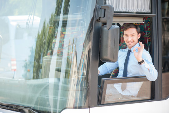 Handsome fit young driver is gesturing positively