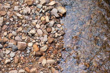 river stone, texture of mixed size of pebbles by the river shore