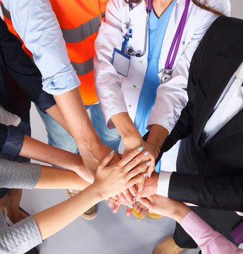 Portrait of people with various occupations putting their hands