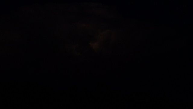 Heat lightning illuminates clouds in the night sky, 4K