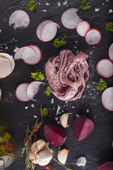 Obraz na płótnie Canvas Fresh Pasta Raw beetroot fresh pasta tagliatelle decor with fresh radish