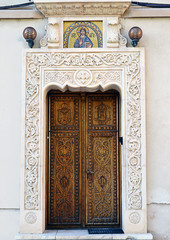 Bucharest, Romania: elaborately carved wooden door with intricat