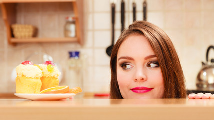 Woman looking at delicious sweet cake. Gluttony. - obrazy, fototapety, plakaty