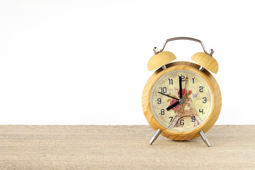Vintage wooden alarm clock on table