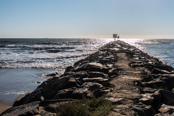 View of the jetty at the Virginia Beach oceanfront extending to the horizon line.  