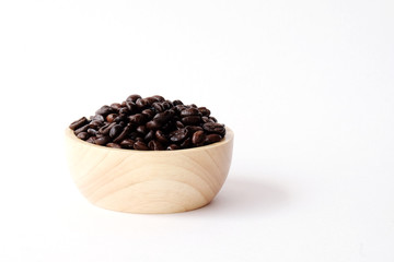 Coffee beans in wooden bowl isolated on white background
