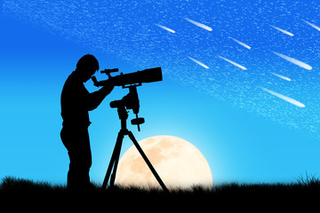silhouette of young man looking through a telescope at the full
