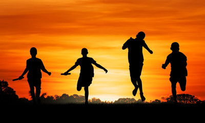 Fototapeta na wymiar sport young boy running go to the winner at sunset background