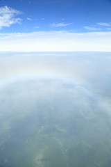Rainbow which suits cloud roundly. Japan seen from the sky.
