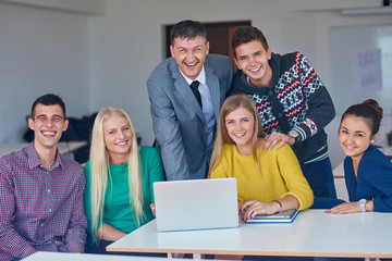 group of students getting suppport from teacher