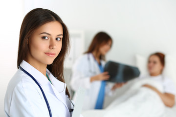 Fototapeta premium Beautiful female medicine doctor looking in camera