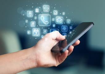 Hand holding smartphone with mobile app icons