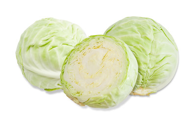 Three heads of cabbage on a light background