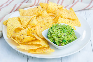 Cup with chunky guacamole served with nachos