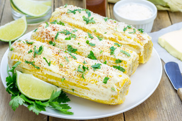 Mexican corn with butter, mayonnaise, parmesan, chili, cilantro, and lime