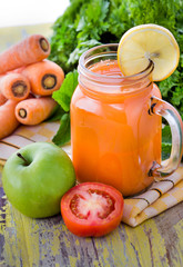 a glass of carrot mix apple and tomato juice