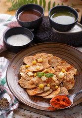 indian snack papri chaat with sauces and yoghurt