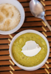 A bowl of thick, fresh, pea soup.