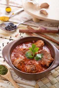 indian lamb rogan josh served on pot with seasoning