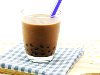 chocolate milk with black jelly on tablecloth