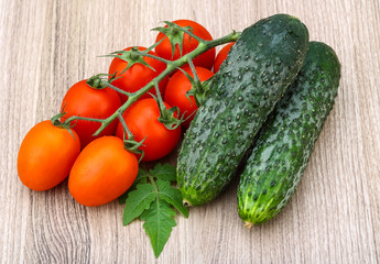 Cucumbers and tomatoes on the branch