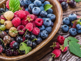 Ripe berries in the wooden bowl.