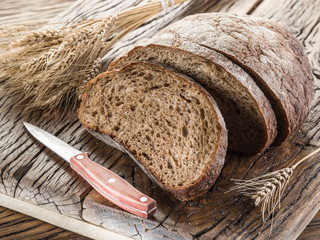 Sliced black bread on the wooden plank.