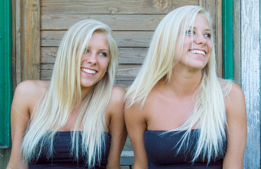 Blonde twins sitting and enjoy the summer
