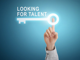 male hand pressing looking for talent key button