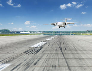 Airplane landing on runaway in the airport.