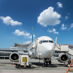Ground service equipment and airplane in the airport.