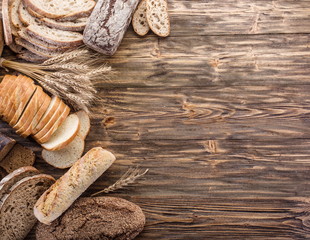 The bread and a wheat on the wooden desk.