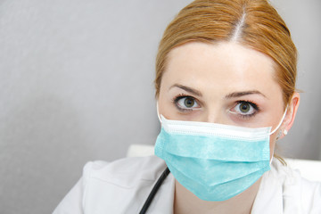 Young female doctor with mask and stethoscope
