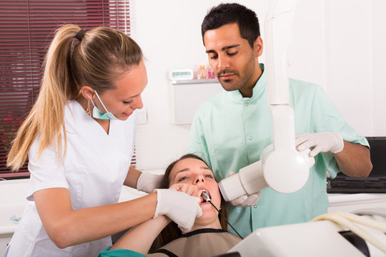 Dentist examines patient at clinic