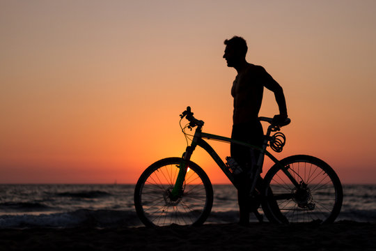 at sunset silhouette of a sportsman on a bike