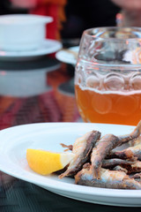 Plate full of fried sprats. Perfect snack.